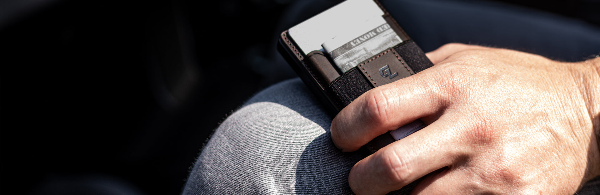 man holding groove wallet go