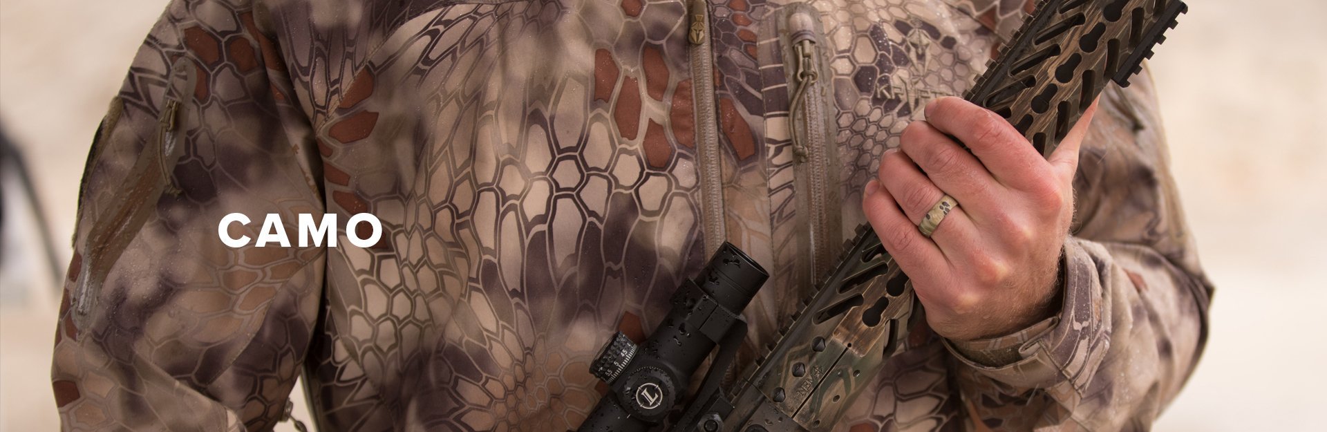 Camo, man holding a rifle while dressed in Kryptek camo