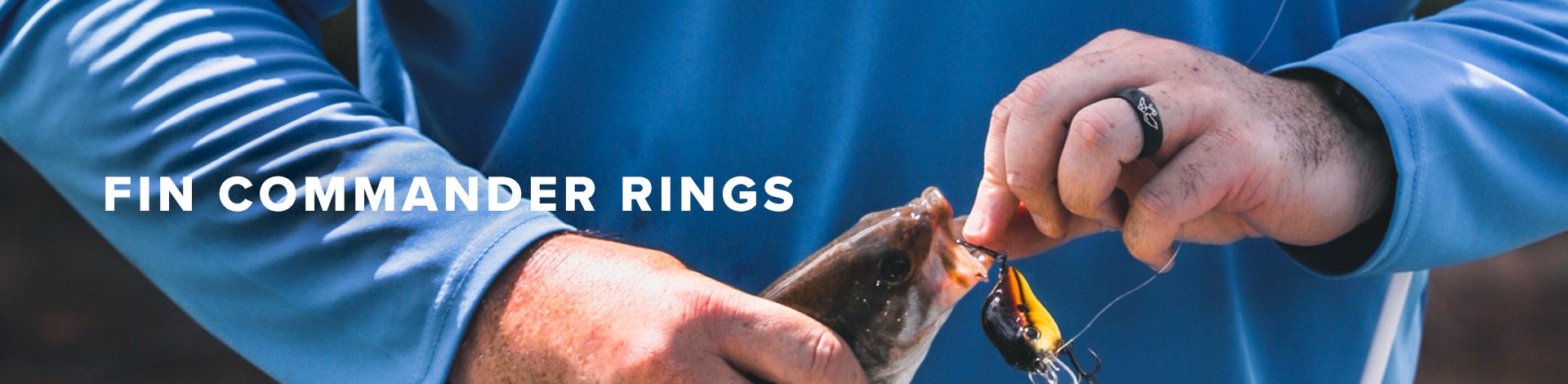 Fin Commander, man unhooks fish he caught