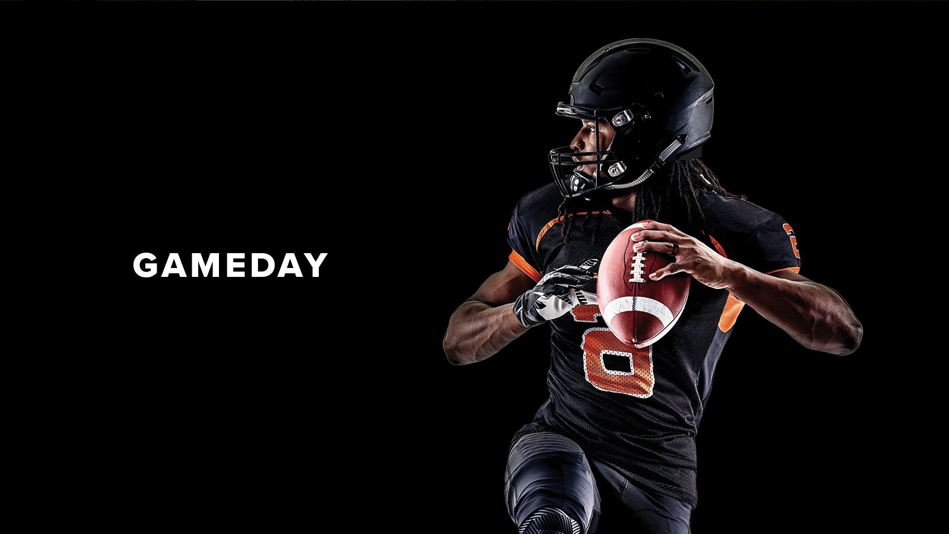Gameday, a football player in black prepares to throw a football