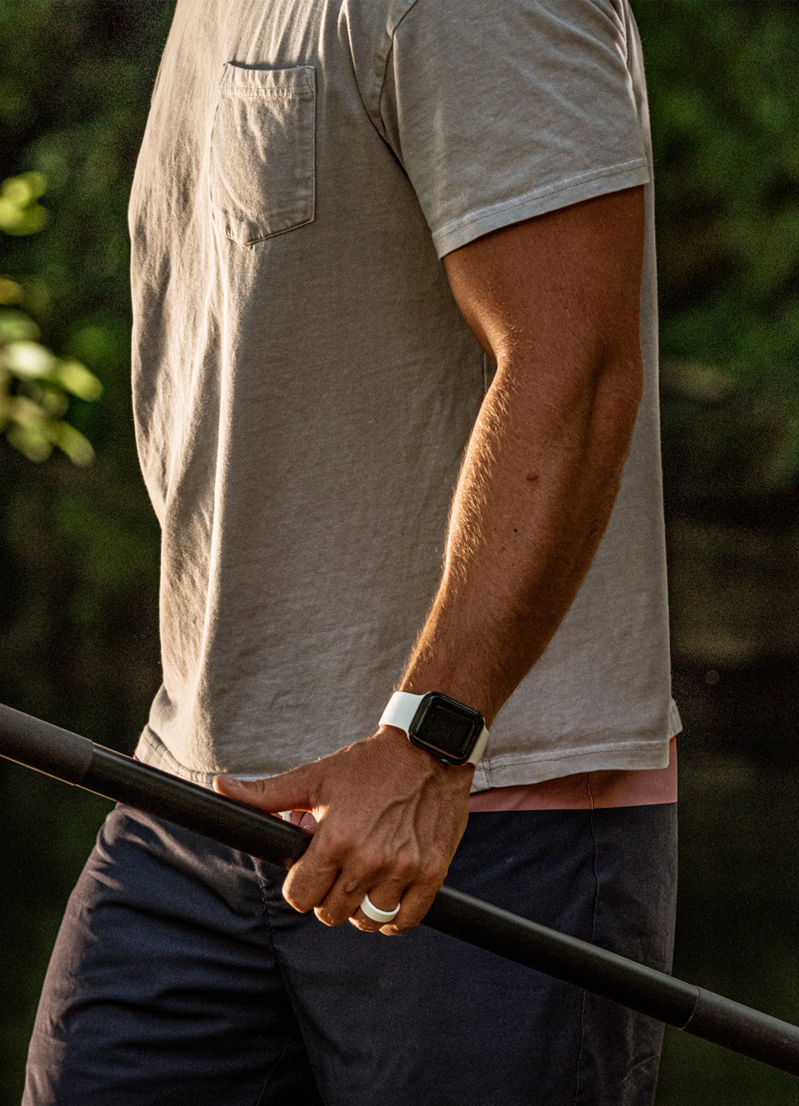 man holding a paddle wearing a Groove Life Apple watch band
