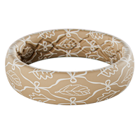 Beige silicone ring with white floral pattern on a white background