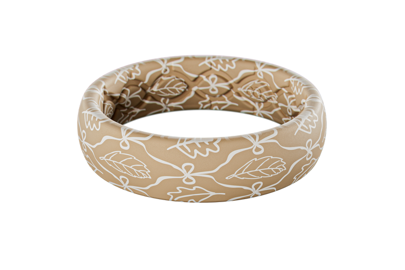 Beige silicone ring with white floral pattern on a white background