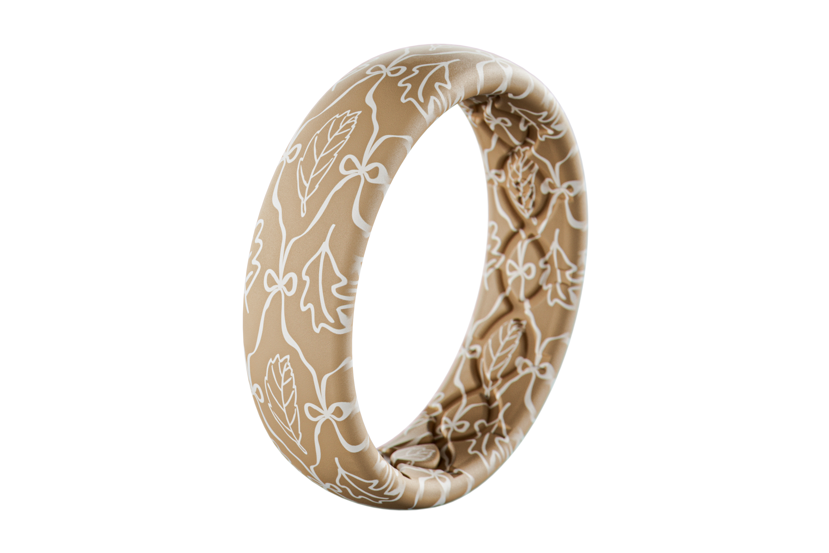 Beige silicone ring with white floral pattern on a white background