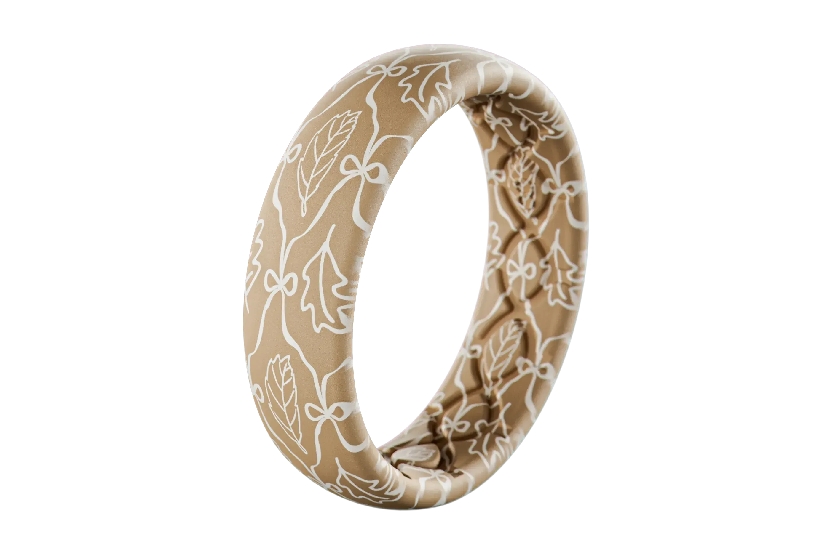 Beige silicone ring with white floral pattern on a white background