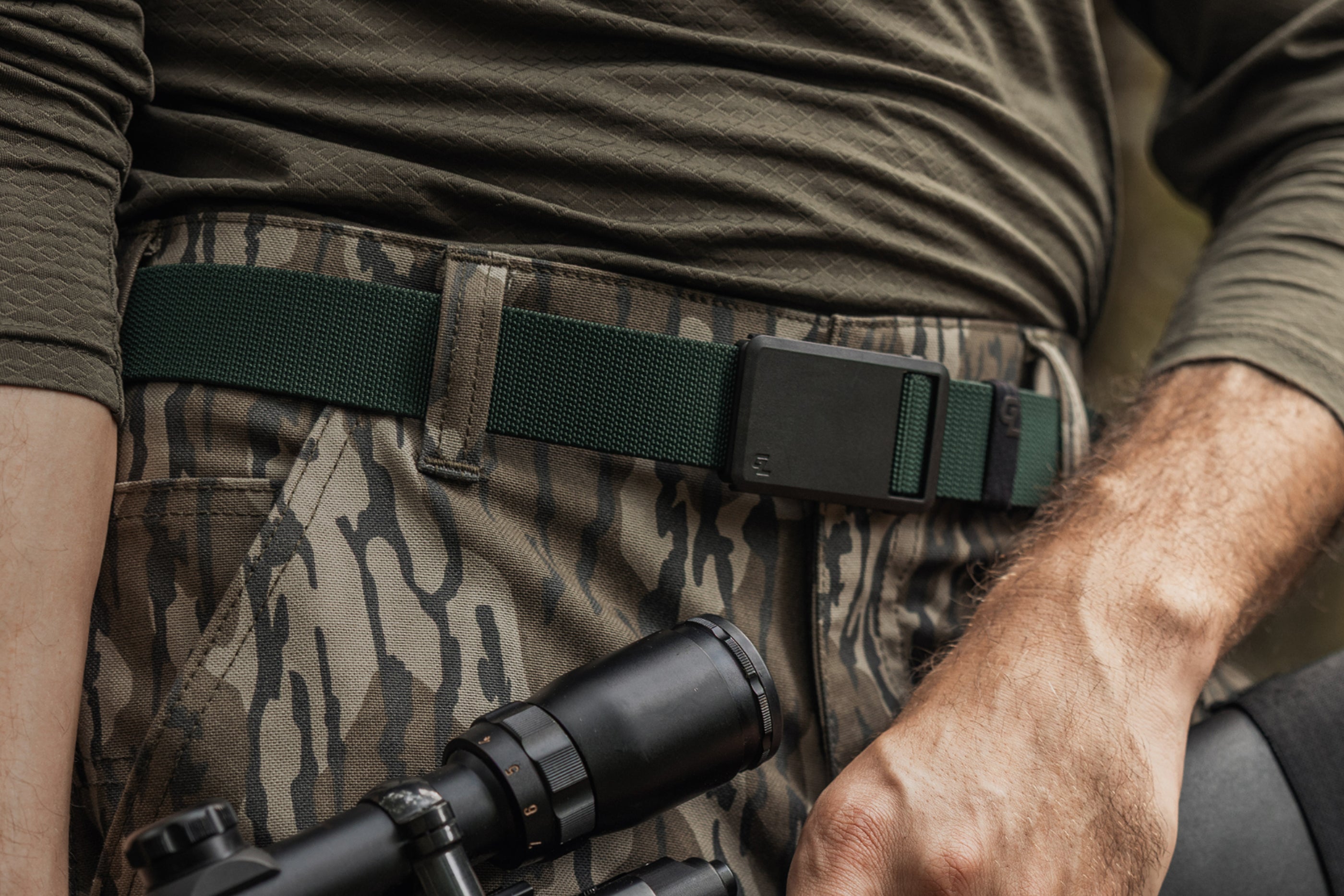 Person wearing a Groove Belt Ultra in Boreal Green with a black buckle 