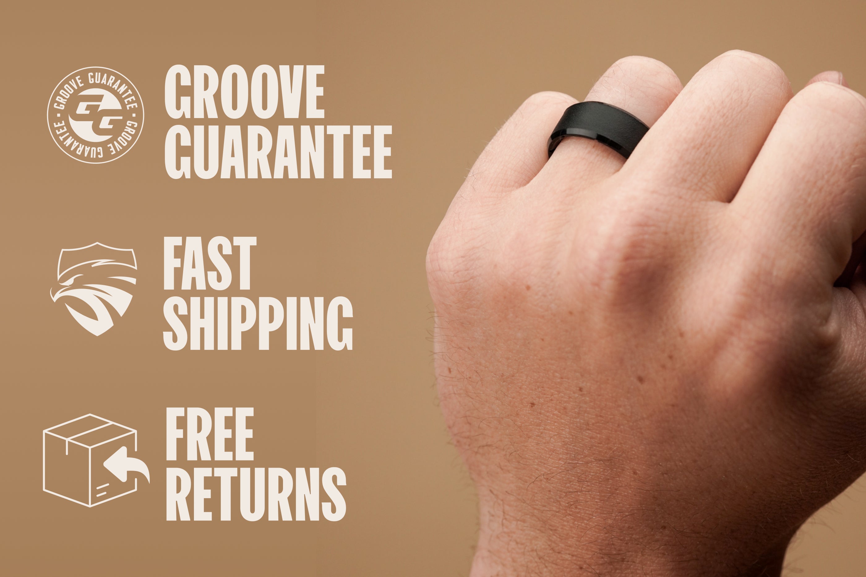 Hand wearing a black ring with Groove Guarantee branding and text on a brown background
