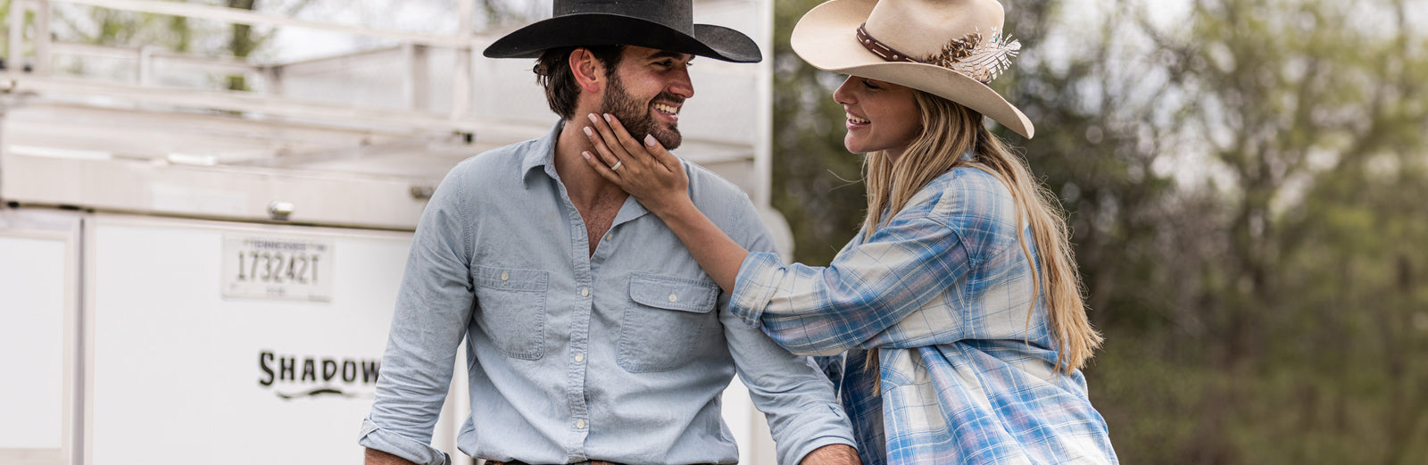 Man and woman smiling at each other wearing Groove Life rings