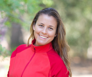 Brooke Sweat smiles in a red sporty jacket