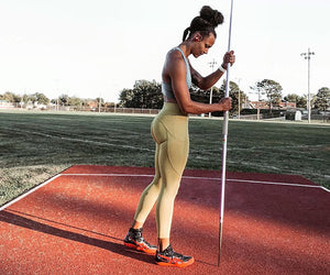 Chantae McMillan Langhorst stands in profile holding a javelin
