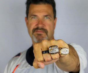 Jason Elam holds his hand up to display his super bowl and groove rings