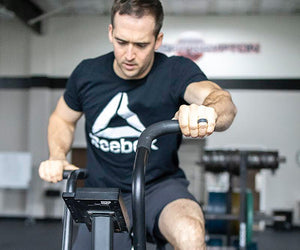 Ben Smith works out on a exercise machine in a gym
