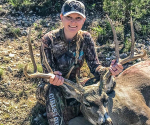 Chelsie Dugan poses with a large 8-point Mule Deer